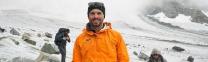 A student in an orange jacket surveys the Dinwood Glacier.